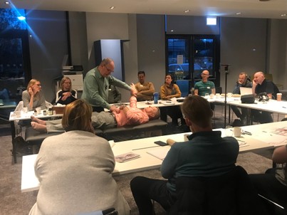 Practitioner demonstrating precision muscle testing during training